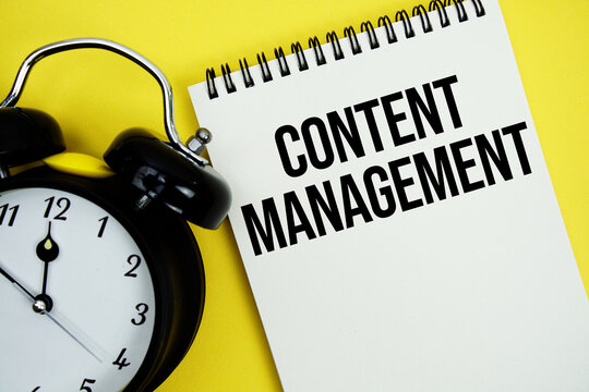 Content Management text with alarm clock flat lay on yellow background