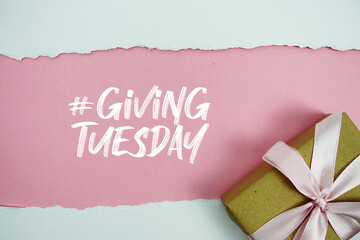 Giving Tuesday text with gift box present on pink background