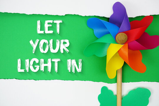 Let Your Light In motivational and inspirational quotes message on green background