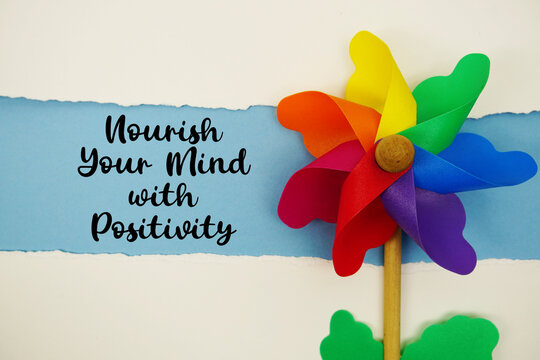 Nourish Your Mind with Positivity motivational and inspirational quotes message on blue background