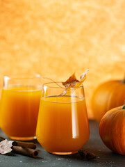 close-up of pumpkin juice in a glass. A healthy, natural autumn drink.
