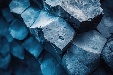 Rugged deep blue-grey hexagonal basalt columns. Natural geometric patterns, textured volcanic rock formation. Reveals ancient geology, creating a powerful, striking abstract.