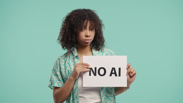 Pretty Woman Holds Sign No Ai With Serious Face, Studio Visual Protest on Blue