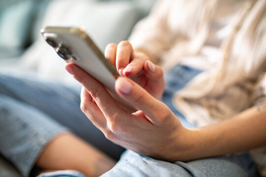 Young woman using smartphone at home