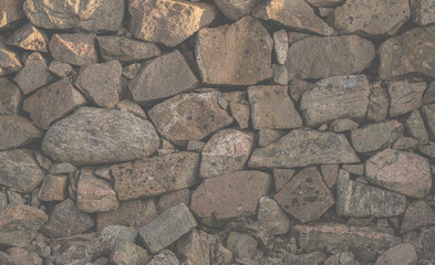Close up of stacked stone wall texture background.