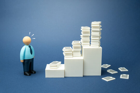 An office worker is amazed at the accumulated paper work. Bureaucracy and ineffective organization of work and reporting. Office overload and administrative inefficiency. Workplace stress