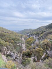 view from the mountain Scenic gorge view in an autumn mountainous landscape with lush green and yellow foliage. Armenian nature and tourism concept