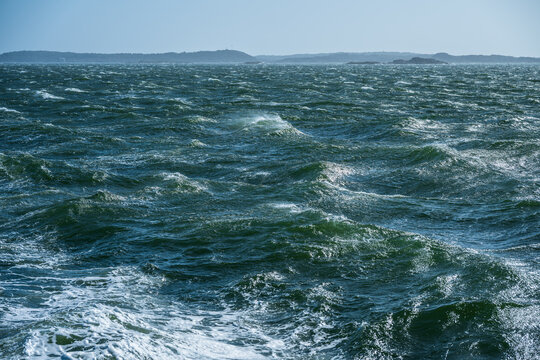 Choppy ocean waters under clear blue sky.