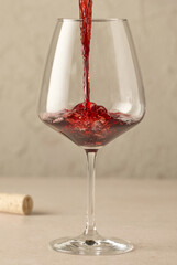 closeup of red wine pouring in glass