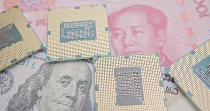 Close-up of semiconductor CPU chips on U.S. dollar and Chinese yuan banknotes. Represents global electronics supply chain, U.S.&ndash;China tech tensions and investment in chips.