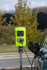 Charging an electric car with power supply cable,Electric car cable connected to a charging station, driving on electricity, charging an electric car, new technology, green energy 