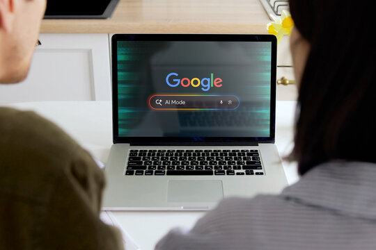 Couple researching ai on google search engine using laptop