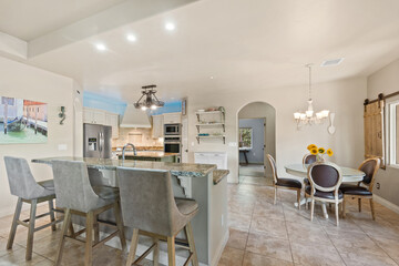 A kitchen equipped with a dining table and several chairs in it