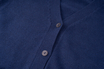 Navy blue merino wool cardigan texture as background.