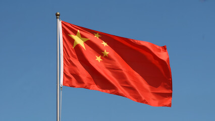 The Chinese flag waved against the blue sky
