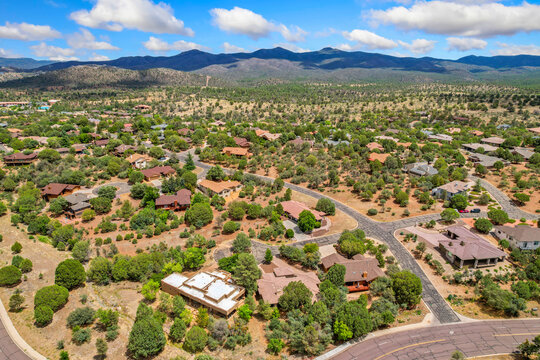 Aerial view of a residential area with mountains behind