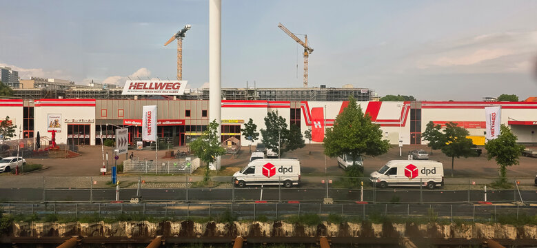 Hellweg hardware store exterior with delivery vans and construction site