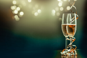 two champagne glasses with ribbons against holiday lights and fireworks - New Year celebrations © Melinda Nagy