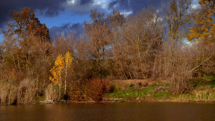 Autumn colors of a provincial region. A local pond and recreation area. A charming autumn landscape.
