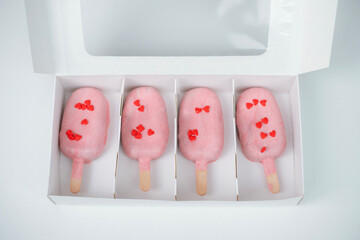 Heart-shaped treats in a box perfect for Valentine's Day celebration with love-themed decorations and a pastel color theme