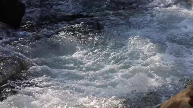 The Zelnytsia river rushes through rocky mountain rapids, producing splashes and water sounds. The landscape emphasizes the wild beauty of the mountains.