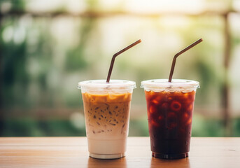 Refreshing iced coffee drinks with straws on a wooden table in natural light
