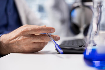 Close up of aged scientist being impatient while waiting for experiment data, reflecting agitation...