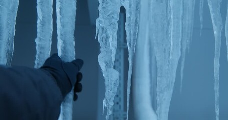 A Frigid Scene Captured: Immense Icicles and Snow Accumulate on Equipment and Structures, Showcasing the Harsh Effects of Winter Weather Conditions in an Industrial Setting