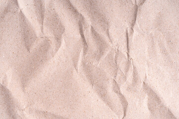 A close up shot of a beige colored crumpled paper texture background view