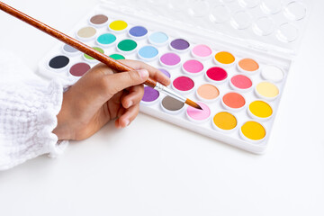 Hand painting with watercolor palette. Creative expression in art