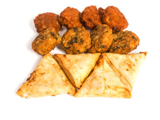 Indian samosa, bhajis and pakoras on white background. Party sharing finger food variety made from fine products and aromatic spices. Special orient vibe. Tasty snack selection.