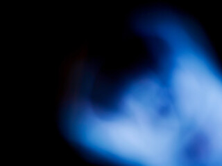 Blue color light leaks on a dark background. Colorful burst of light for design or special effects.