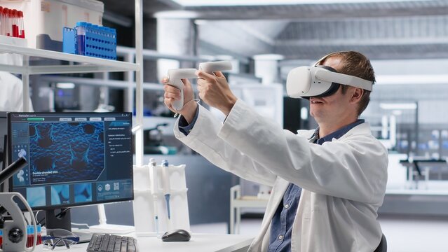 Male chemist using VR glasses in research lab for molecular biology experiment. Virtual reality transforms biotechnology and genetics research in modern interactive laboratory tasks.