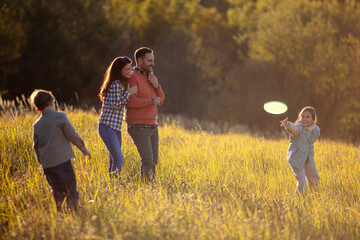 Parents watch children play with frisbee