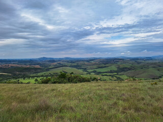 Naklejka premium meadow view with clouds and mountains