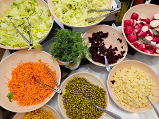 Buffet bar filled with fresh vegetables and garnishes ready for customers to make their salads