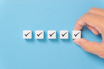 Checklist concept, Check mark on dice, blue background with copy space