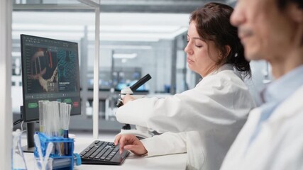 Clinical microbiologist checking time, waiting to finish shift, processing patient data. Diagnostic laboratory manager using PC to do genetic analysis diagnostics checking wrist watch clock - Powered by Adobe