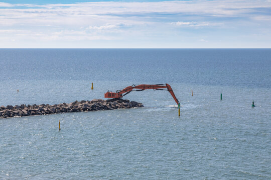Dredging Equipment on the Jetty in the Harbor of Bornholm, Denmark on a Sunny Summer Day