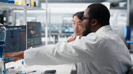 Multiracial engineers using scientific gear in research facility used for complex experiments. Diverse team of scientists in high tech laboratory doing genetics research using lab equipment, camera B - Powered by Adobe