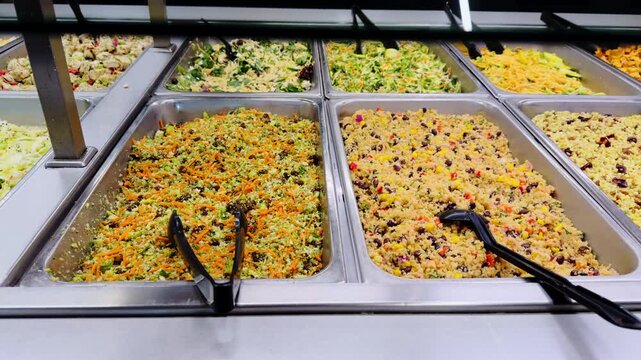 Variety of dishes ready to eat in the grocery store neatly displayed in trays on shelves. Close up