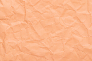 Peach pink color abstract texture of crumpled paper, empty background with wrinkles for overlay