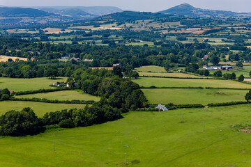 Patchwork landscape of green pastures, fields, and trees in the Welsh countryside © whitcomberd