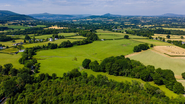 Aerial drone view of green fields and rural farmland in Monmouthshire, Wales