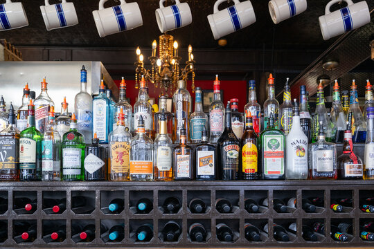 Newfoundland, Canada-October 1, 2025: Rows of liquor bottles: Captain Morgan, Jack Daniels, Vodka, Kahlua, Triple Sec, Fireball, Sambuca, Gin, Contreau, Bailey's, Malibu, and whisky on a bar shelf. 