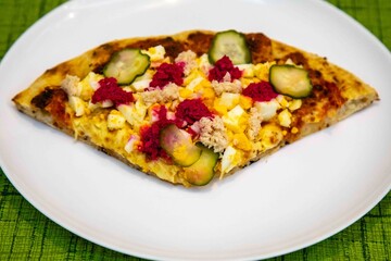 Exotic and original Brazilian pizza with two flavors, one with anchovies and the other with egg, horseradish, and cucumber pickles.