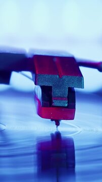 Retro Vinyl record player playing music, close-up macro shot of vintage LP disc old phonograph spinning. Retro music player at home.