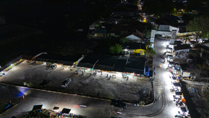 The atmosphere of Waingapu's Old Town to the Seaport seen from the air with a drone at night