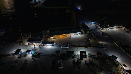 The atmosphere of Waingapu's Old Town to the Seaport seen from the air with a drone at night