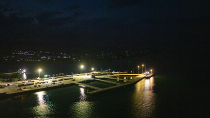The atmosphere of Waingapu's Old Town to the Seaport seen from the air with a drone at night